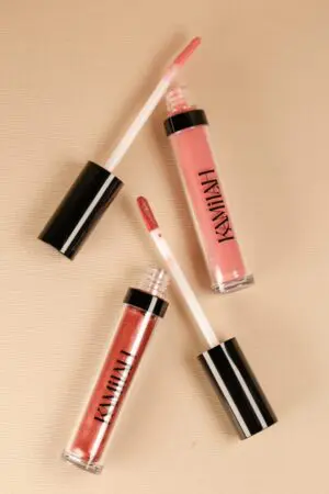 Three lipsticks are shown on a table.