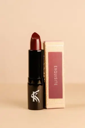 A lipstick that is sitting next to a box.